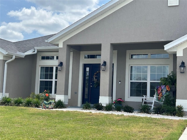 25 NW 45th Loop, Ocala, FL 34475 - property entrance featuring roof with shingles, a yard, and stucco siding