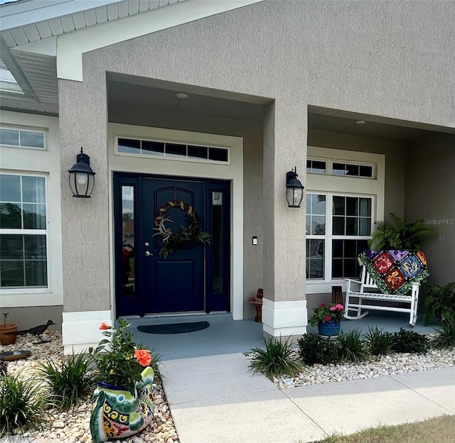 25 NW 45th Loop, Ocala, FL 34475 - property entrance with covered porch and stucco siding