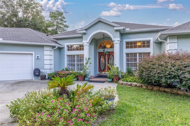 ranch-style house with a garage and a front lawn