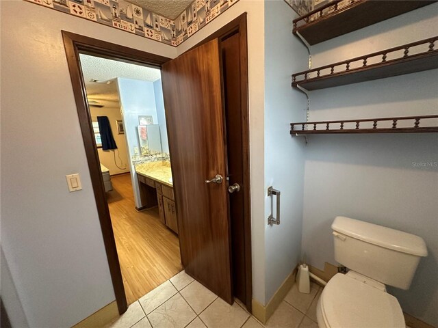 bathroom with vanity, toilet, and tile patterned floors