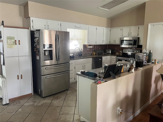 kitchen featuring backsplash, sink, stainless steel appliances, and white cabinets