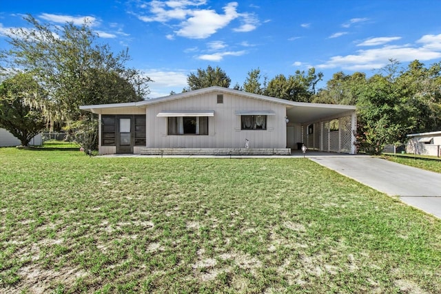 view of front facade featuring a carport and a front yard