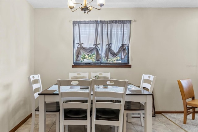 dining room featuring light tile patterned flooring and a chandelier