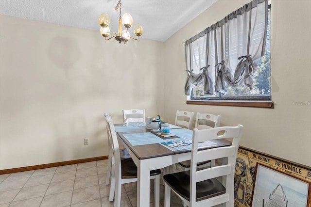 dining space featuring a notable chandelier, a textured ceiling, and light tile patterned floors