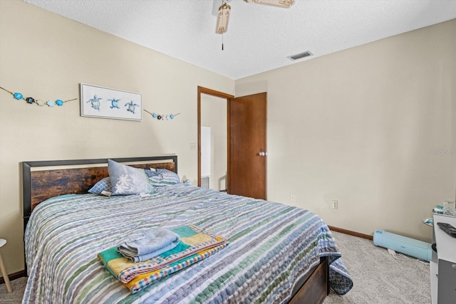 bedroom featuring a textured ceiling and carpet flooring