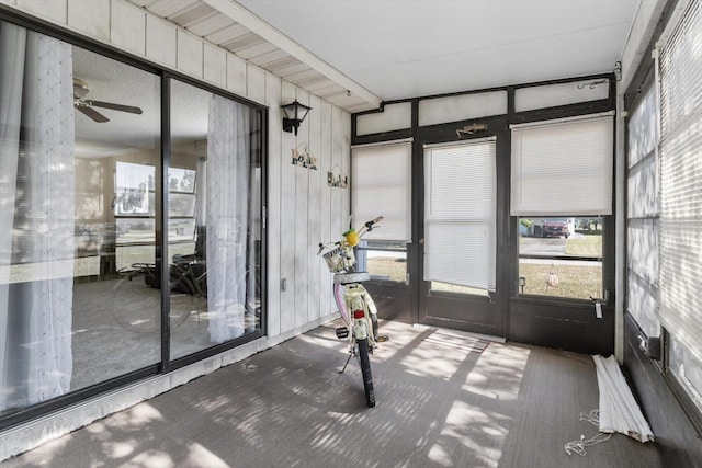 unfurnished sunroom featuring ceiling fan