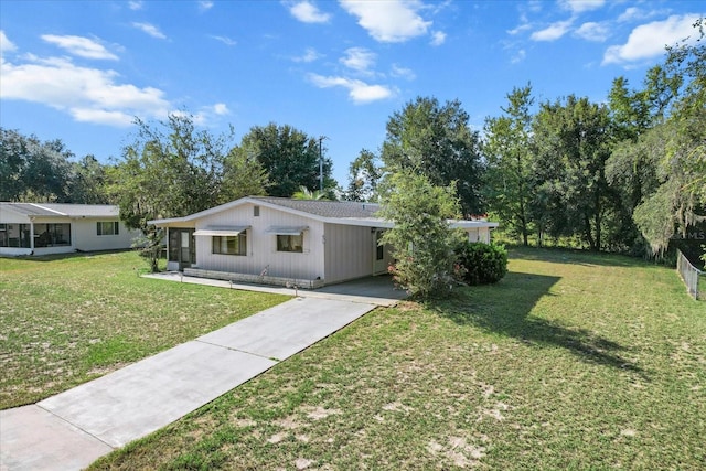 single story home featuring a carport and a front lawn