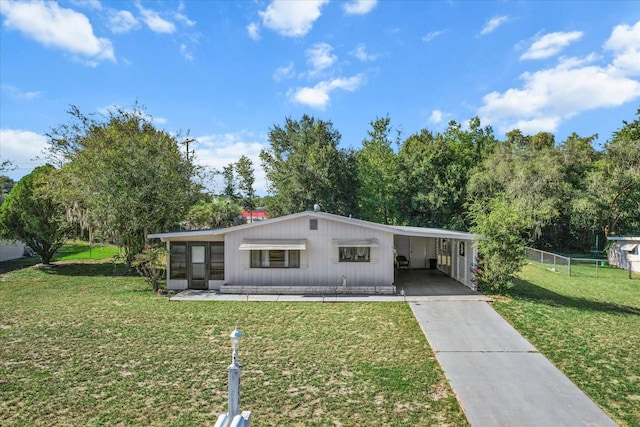 view of front of house featuring a front lawn and a carport