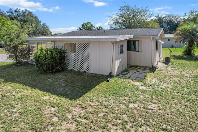 rear view of property with a lawn