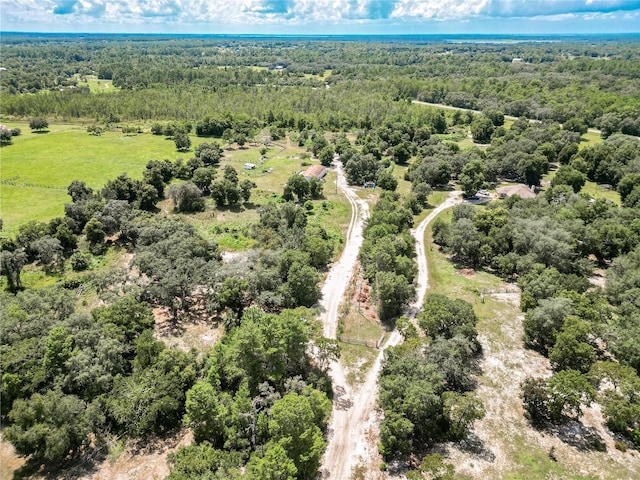 birds eye view of property with a view of trees