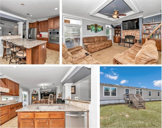 kitchen with a center island with sink, appliances with stainless steel finishes, open floor plan, a breakfast bar area, and a sink