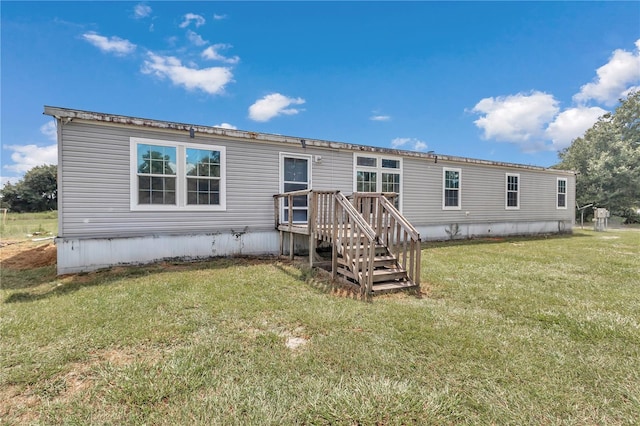 rear view of property featuring a yard