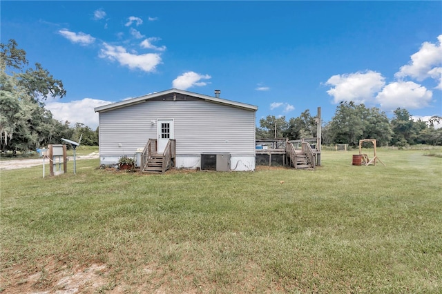 exterior space featuring central AC and a lawn