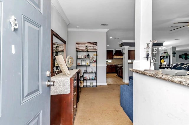 foyer entrance featuring ceiling fan, recessed lighting, crown molding, visible vents, and ornate columns