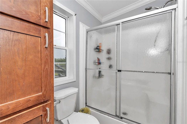 bathroom featuring a wealth of natural light, toilet, vaulted ceiling, and ornamental molding