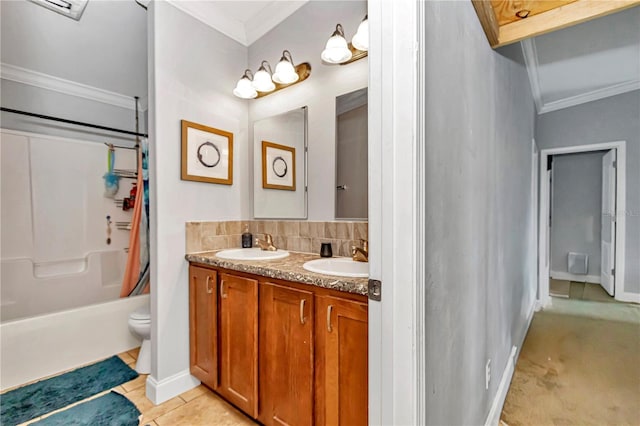 bathroom with double vanity, tile patterned floors, a sink, and crown molding