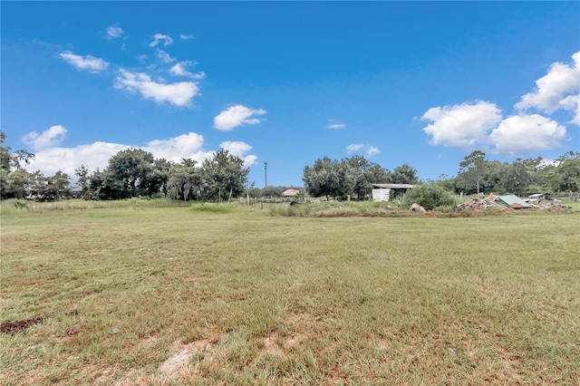 view of yard with a rural view