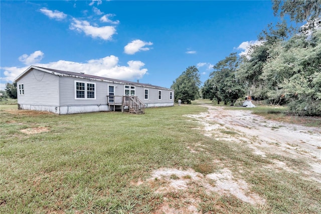 back of house with a lawn