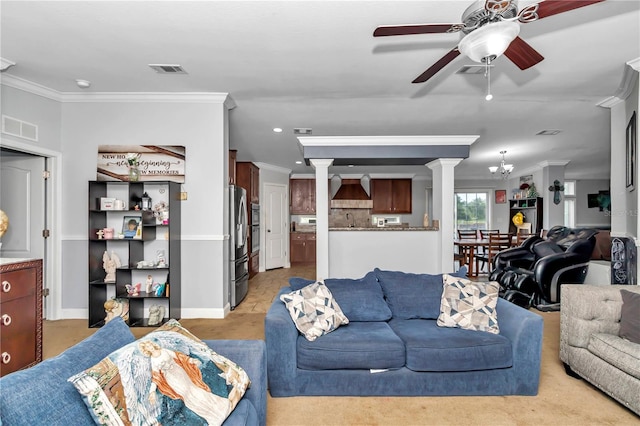 living area featuring ornamental molding, visible vents, and ceiling fan with notable chandelier