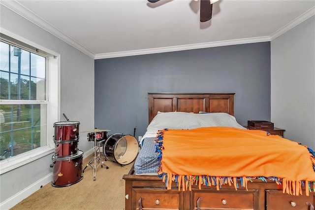 carpeted bedroom with baseboards, ceiling fan, and crown molding