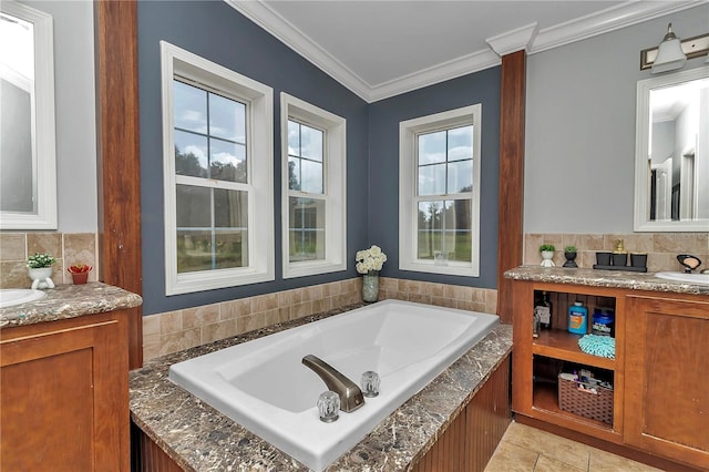 bathroom with tile patterned floors, a washtub, vanity, and ornamental molding