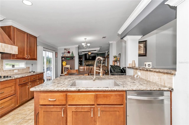 kitchen with light stone counters, open floor plan, light tile patterned flooring, and stainless steel dishwasher