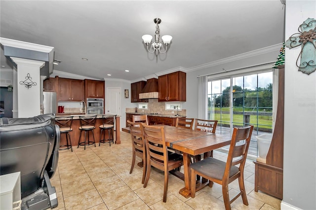 dining space featuring ornamental molding, sink, light tile patterned floors, and a chandelier