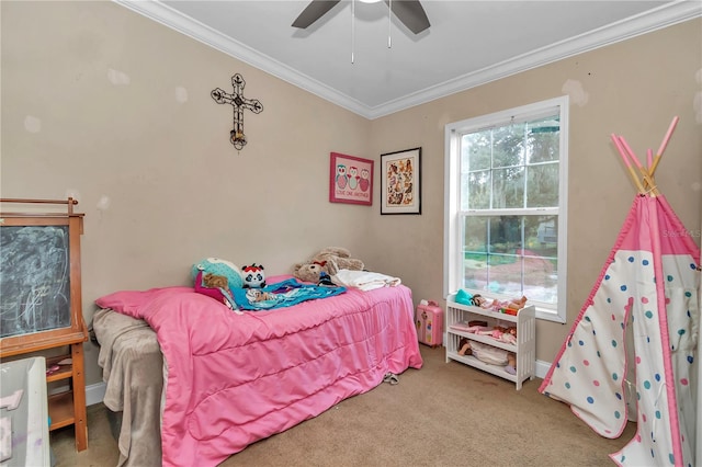 carpeted bedroom featuring baseboards, ornamental molding, and a ceiling fan