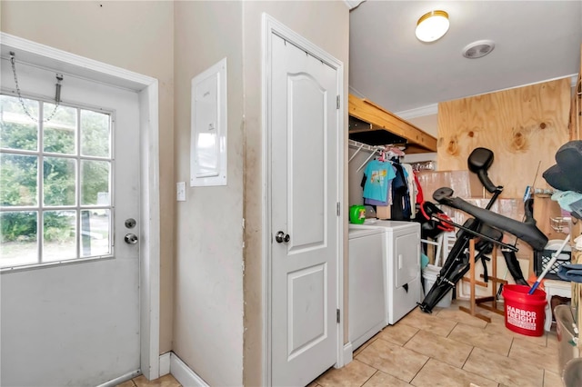 interior space featuring washing machine and dryer, laundry area, and light tile patterned floors