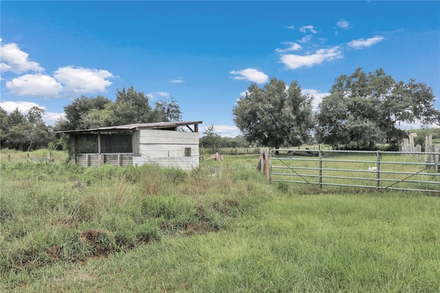 view of yard featuring a rural view and fence