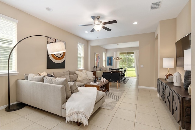 tiled living room with ceiling fan