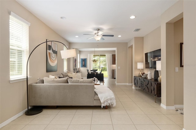 tiled living room with ceiling fan