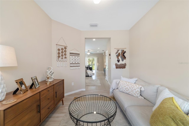 living room with ceiling fan and light hardwood / wood-style floors