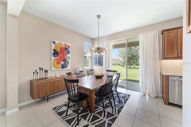 tiled dining area with plenty of natural light and a chandelier