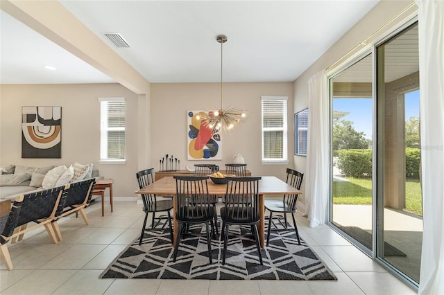 dining space with an inviting chandelier and light tile patterned flooring