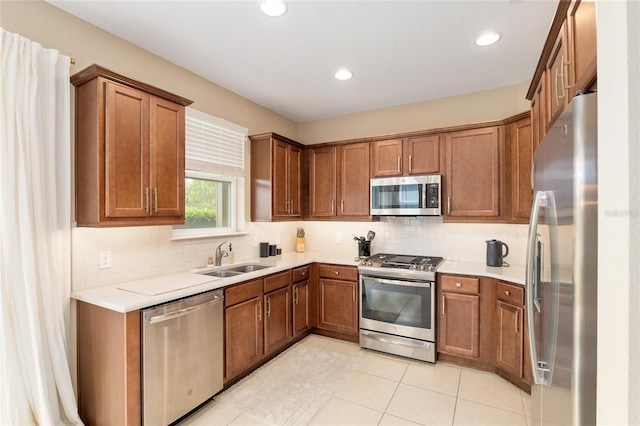 kitchen featuring light tile patterned floors, stainless steel appliances, tasteful backsplash, and sink