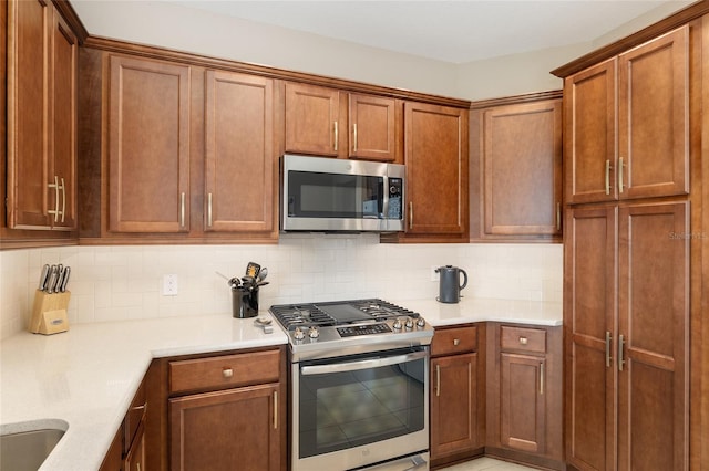 kitchen featuring appliances with stainless steel finishes and backsplash