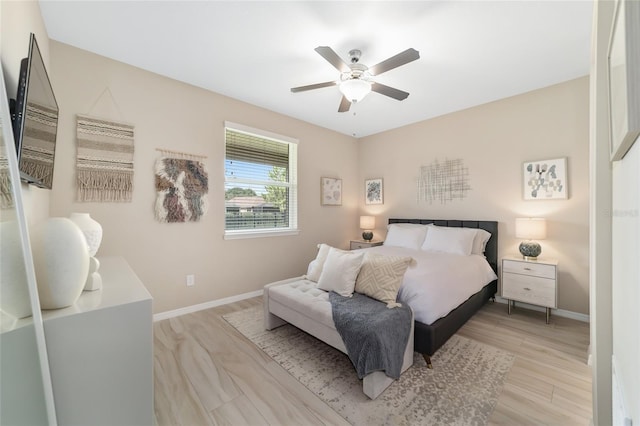 bedroom with light wood-type flooring and ceiling fan