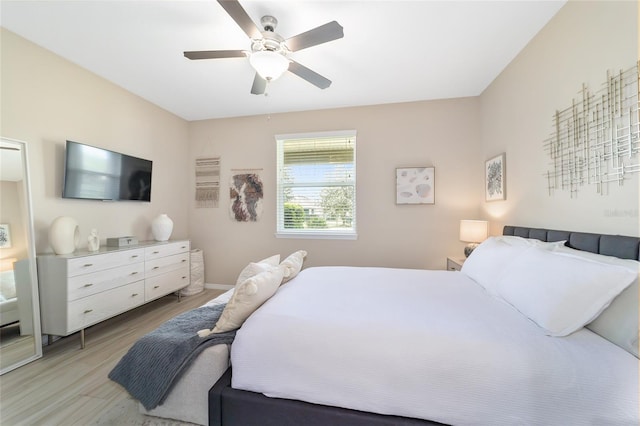 bedroom featuring light hardwood / wood-style flooring and ceiling fan