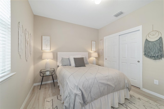 bedroom featuring light hardwood / wood-style floors and a closet