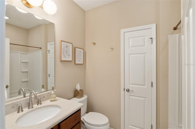 bathroom featuring walk in shower, toilet, and vanity