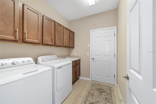 washroom with light tile patterned floors, cabinets, independent washer and dryer, and sink