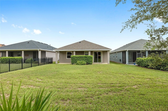 rear view of house featuring a yard