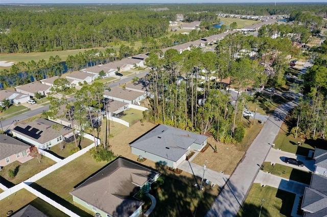 drone / aerial view with a residential view and a forest view