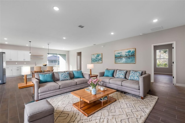 77 Edith Pope Dr, Palm Coast, FL 32164 - living room featuring plenty of natural light, dark wood finished floors, recessed lighting, and baseboards