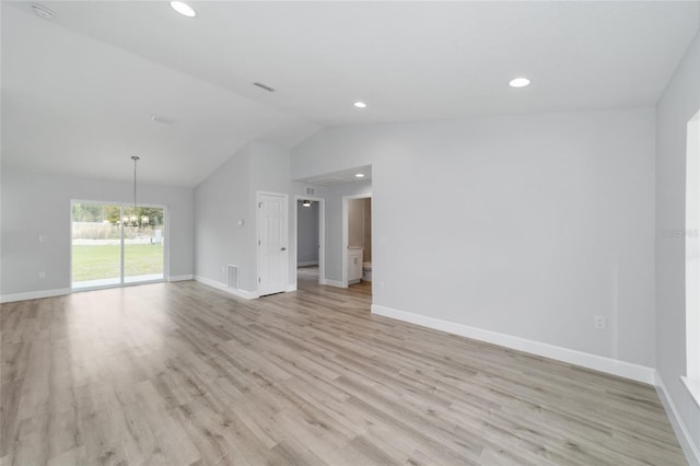 unfurnished living room with a notable chandelier, light wood-type flooring, baseboards, and vaulted ceiling