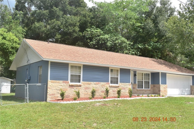 view of front of property with a garage and a front yard