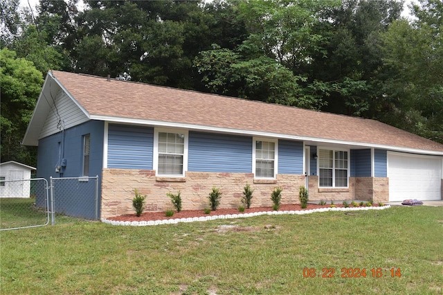 view of front facade featuring a garage and a front lawn