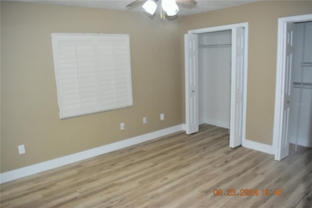 unfurnished bedroom featuring light wood-type flooring and ceiling fan