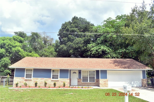 single story home featuring a front yard and a garage